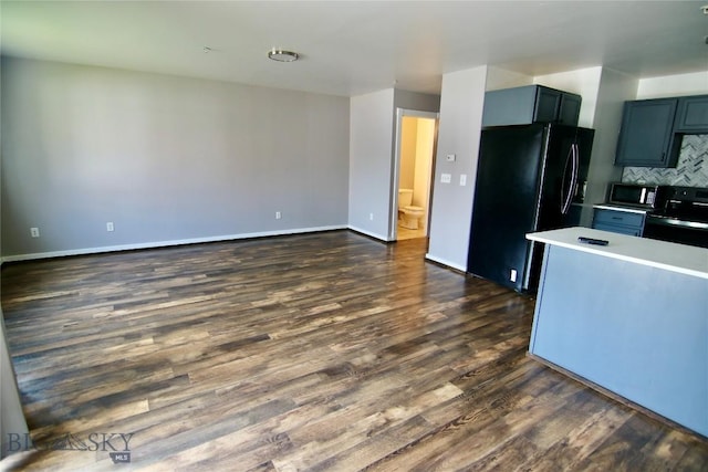 kitchen featuring tasteful backsplash, baseboards, dark wood-style floors, light countertops, and black appliances