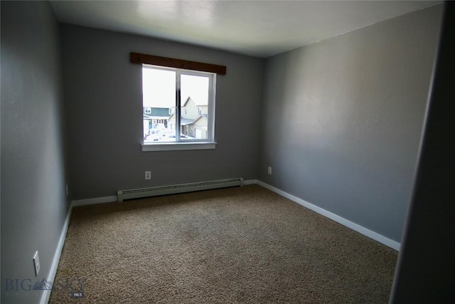 carpeted spare room with a baseboard heating unit and baseboards