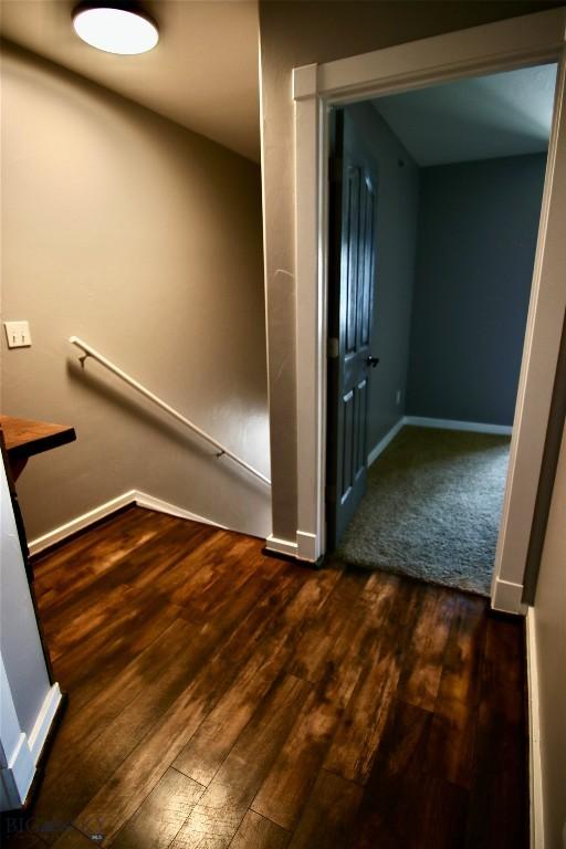 interior space with baseboards and wood finished floors