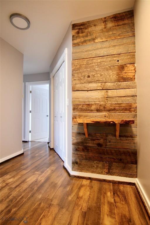 hallway with wood finished floors and baseboards