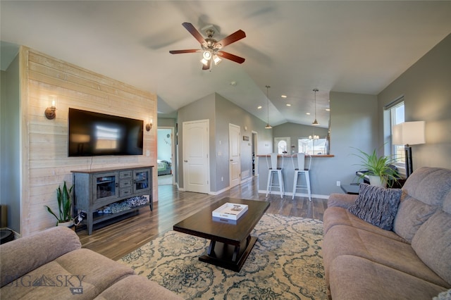 living room featuring ceiling fan, lofted ceiling, and dark wood-type flooring