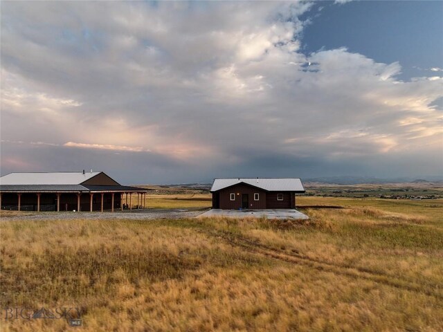 outdoor structure at dusk with a rural view