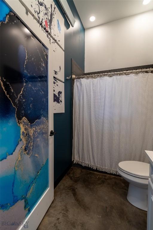 bathroom featuring concrete flooring and toilet