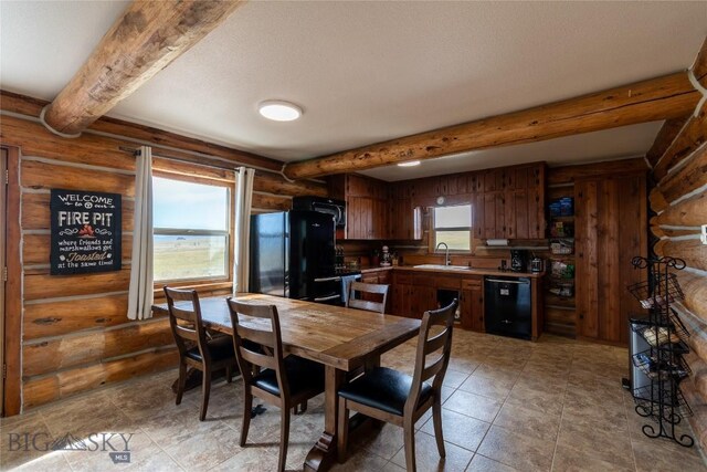 dining space featuring a healthy amount of sunlight, sink, and beam ceiling