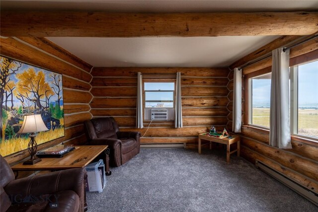 sitting room featuring rustic walls, a healthy amount of sunlight, beamed ceiling, and a baseboard heating unit