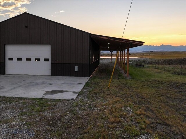 exterior space featuring a yard, a mountain view, and a garage