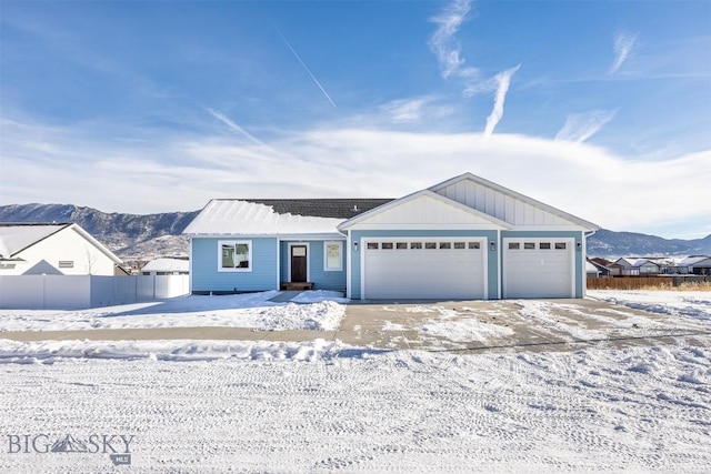 ranch-style house with a garage and a mountain view