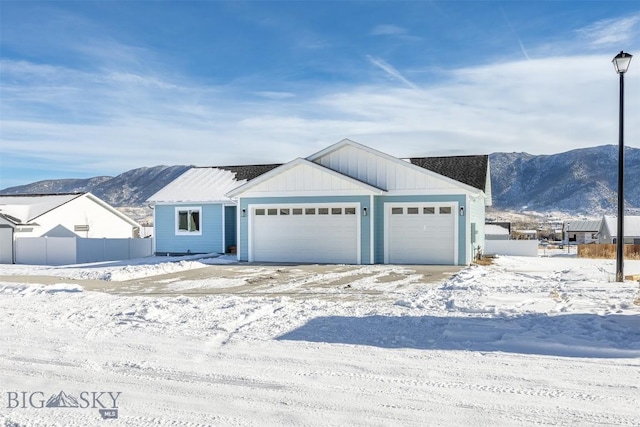 view of front of property featuring a garage and a mountain view