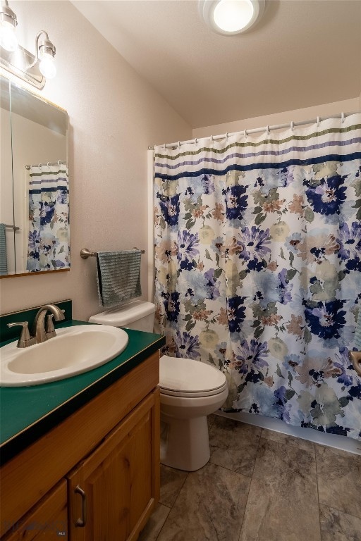 bathroom featuring toilet, tile patterned flooring, and vanity