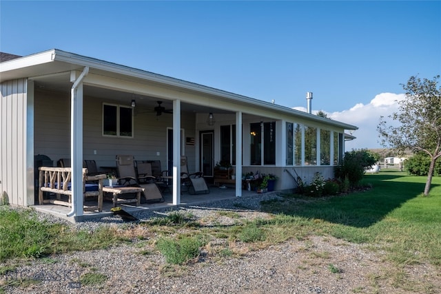 back of house with ceiling fan, an outdoor hangout area, a patio area, and a lawn