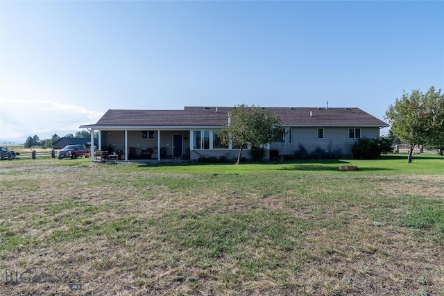 back of house featuring a lawn