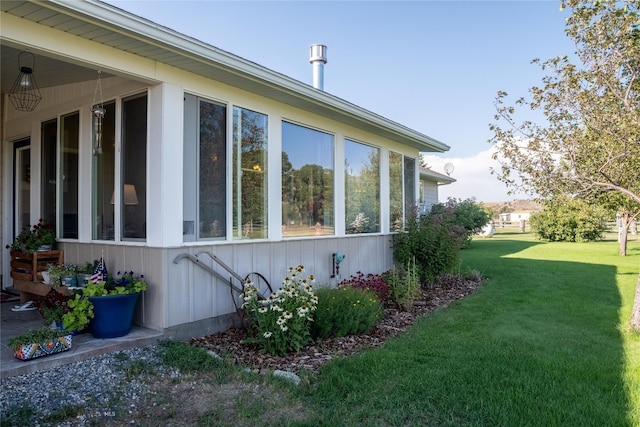 view of side of home with a lawn