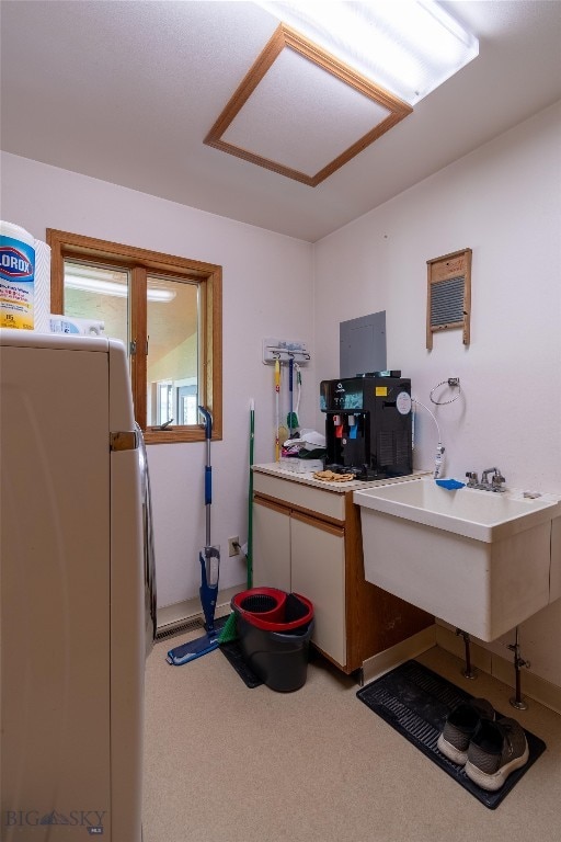 carpeted office space with sink and electric panel