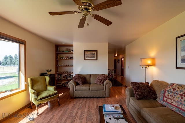 living room featuring hardwood / wood-style flooring, a healthy amount of sunlight, and ceiling fan