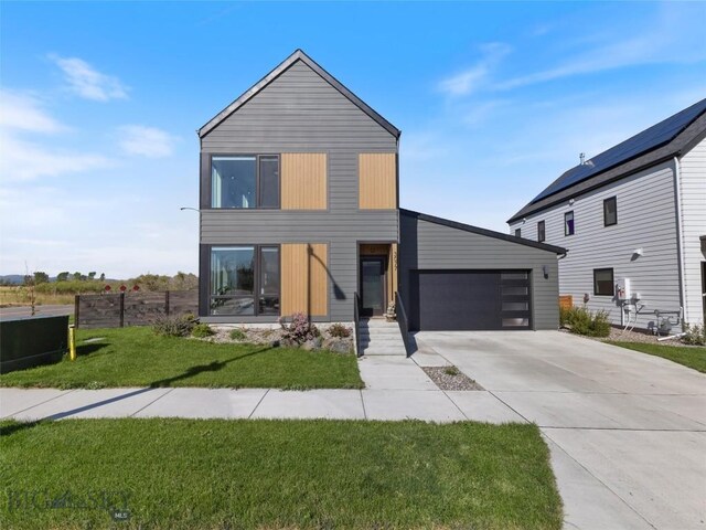 view of front of house with a garage and a front yard