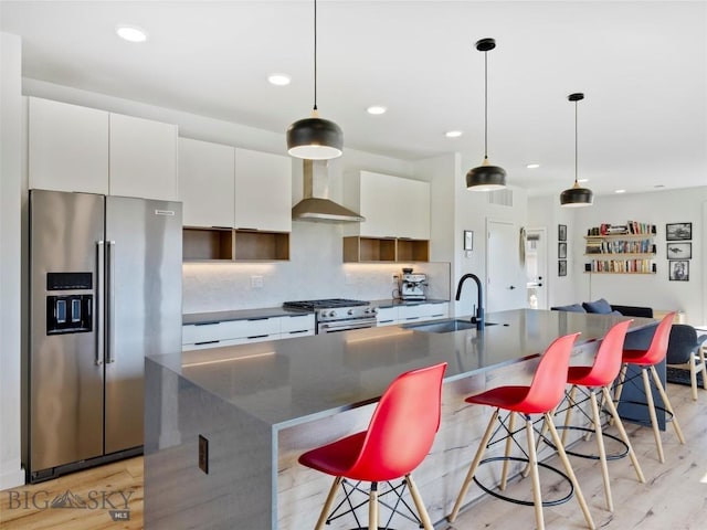 kitchen featuring wall chimney exhaust hood, open shelves, white cabinets, and premium appliances