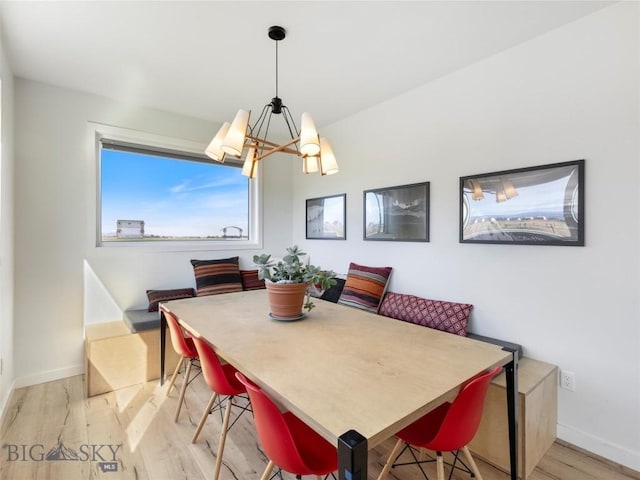 dining room with light wood-style flooring and baseboards