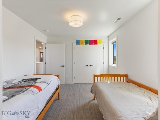 bedroom featuring baseboards, visible vents, a closet, and carpet floors