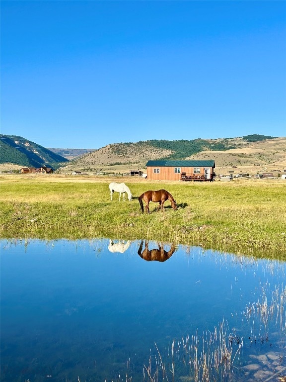 drone / aerial view featuring a water and mountain view