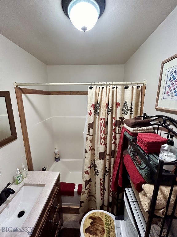 bathroom featuring vanity and shower / bathtub combination with curtain