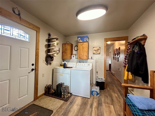 washroom with washer and dryer, dark hardwood / wood-style flooring, and cabinets