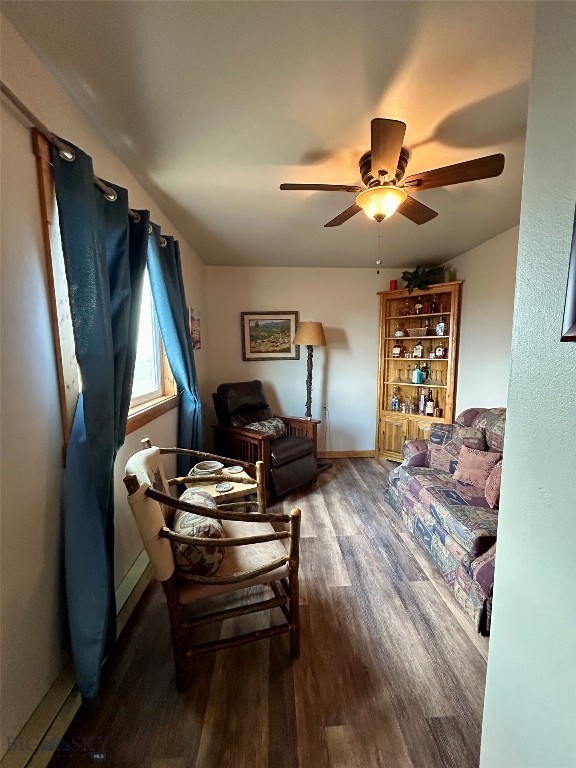 living room featuring hardwood / wood-style flooring and ceiling fan