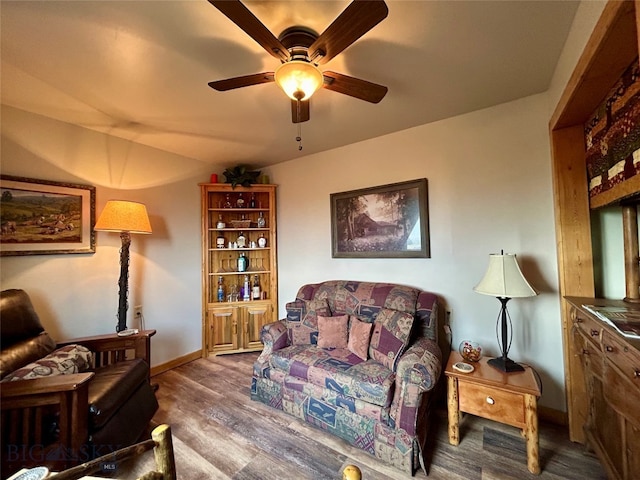 living room with ceiling fan and dark hardwood / wood-style floors