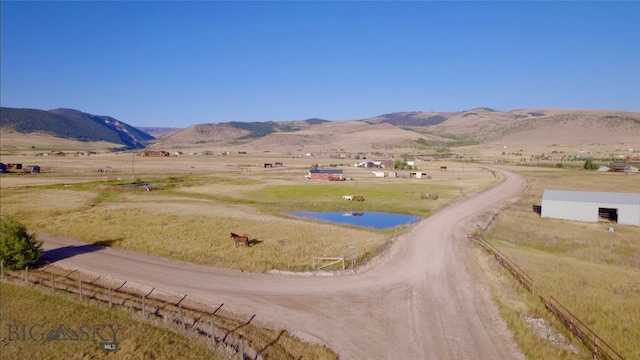 exterior space with a rural view and a mountain view