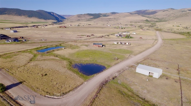 birds eye view of property featuring a rural view and a water and mountain view