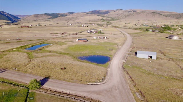 bird's eye view with a rural view and a water and mountain view