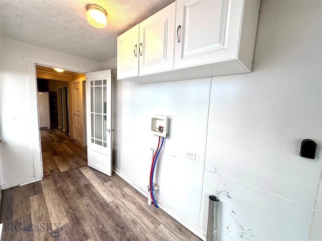 laundry area with cabinets, washer hookup, and hardwood / wood-style floors