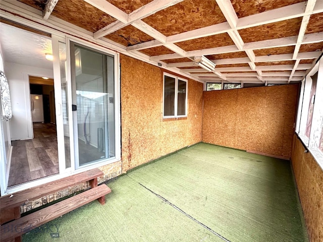 unfurnished sunroom featuring coffered ceiling