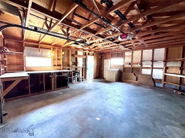 garage featuring a workshop area and a garage door opener