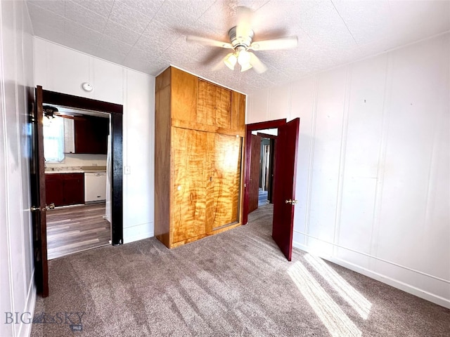 unfurnished bedroom with ceiling fan and carpet floors