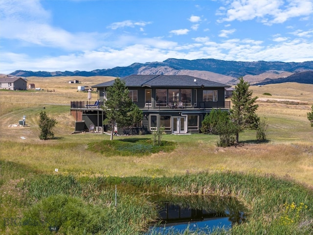 back of house featuring a rural view and a mountain view