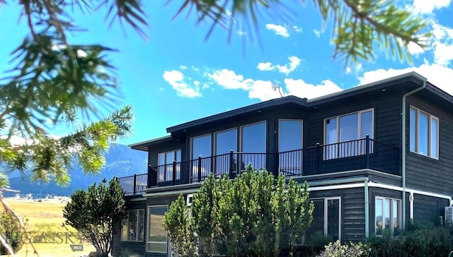 view of side of home with a balcony