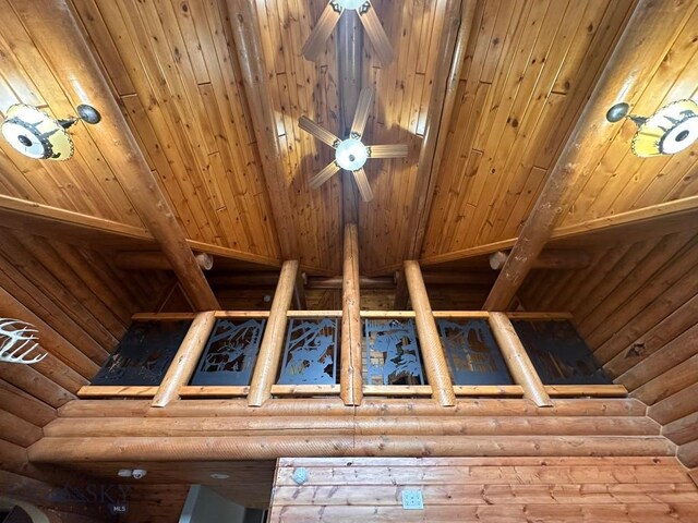 details featuring log walls, ceiling fan, and wood ceiling