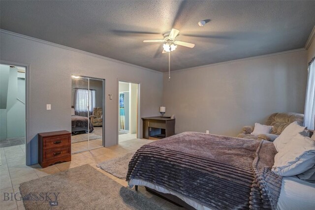 tiled bedroom with a textured ceiling, crown molding, and ceiling fan