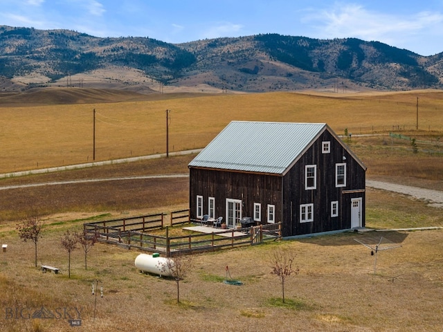 view of outdoor structure with a rural view and a mountain view