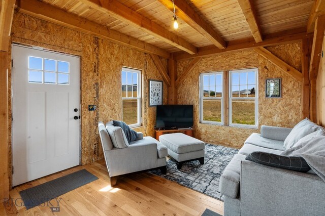 living room featuring beamed ceiling, wooden ceiling, and wood-type flooring