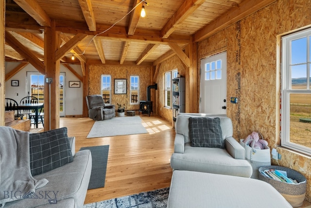 living room with wood ceiling, beamed ceiling, and light wood-type flooring