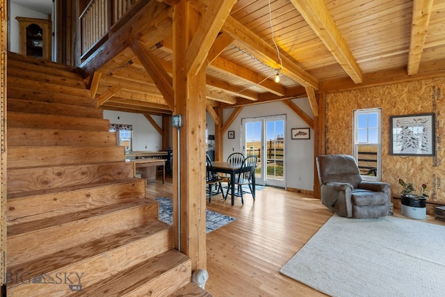 living room featuring beamed ceiling, wooden ceiling, and light hardwood / wood-style flooring