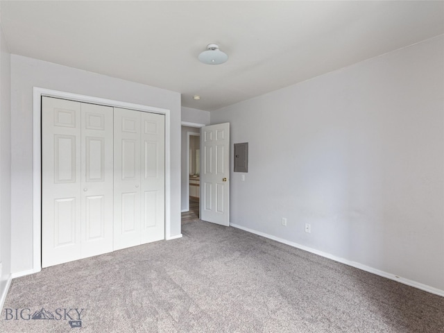 unfurnished bedroom with carpet floors, a closet, and electric panel