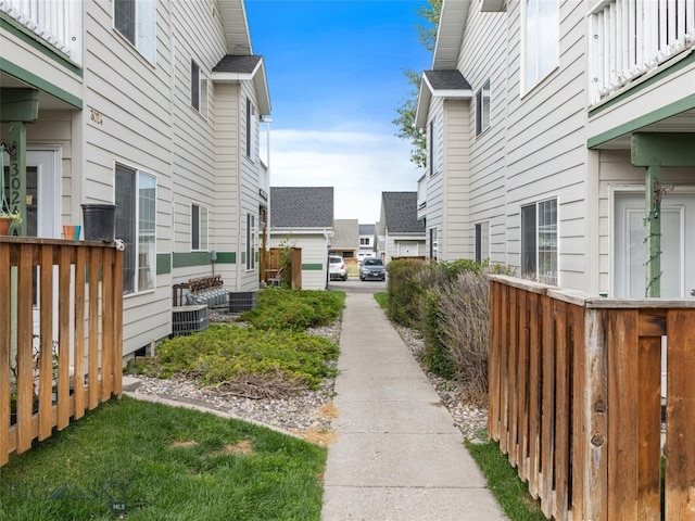 view of yard featuring central AC unit and a balcony