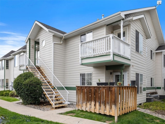 exterior space with a balcony and central AC unit