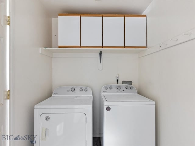 washroom featuring washing machine and dryer and cabinets