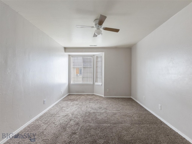 spare room featuring carpet flooring and ceiling fan