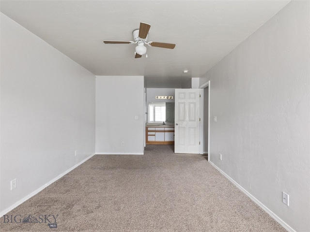 empty room with ceiling fan and carpet floors