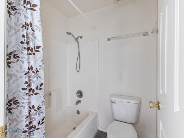 bathroom with shower / tub combo and toilet