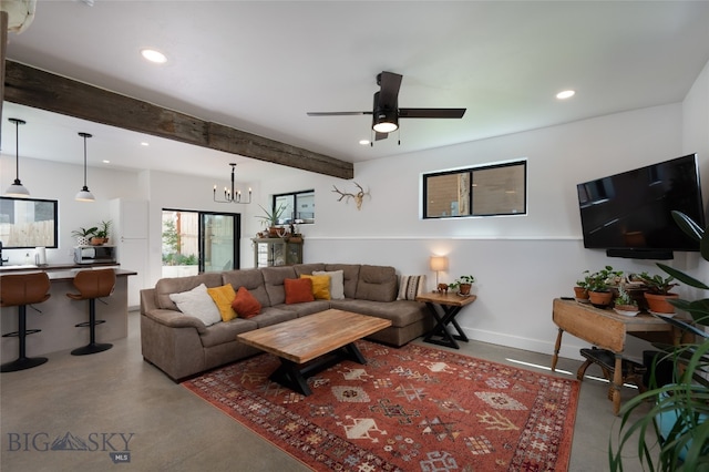 living room featuring ceiling fan with notable chandelier, beamed ceiling, and concrete flooring